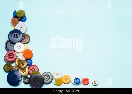 multi-colored buttons lie on a blue surface Stock Photo
