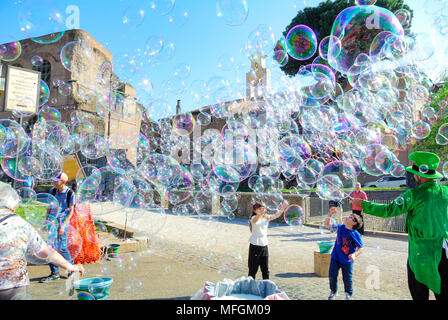 Street performance, A busker blowing giant soap bubbles with loops , rome, italy Stock Photo