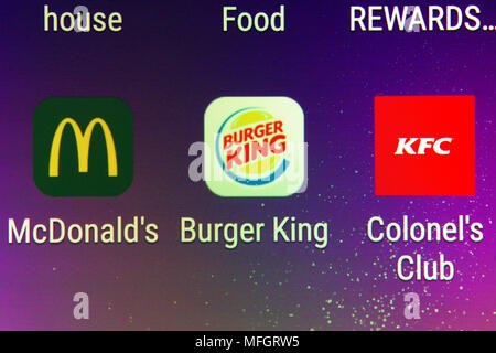 A closeup on the Burger King, McDonald's and KFC mobile phone apps Stock Photo