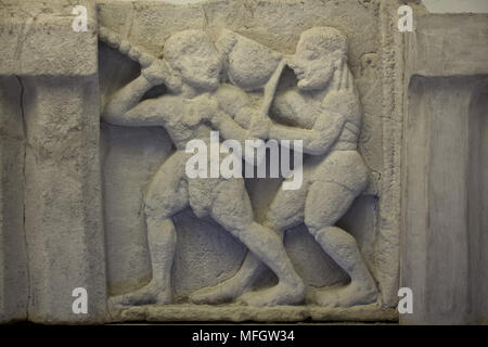 Apollo and Heracles struggle for the Delphic tripod. Archaic sandstone metope from the Heraion (First Temple of Hera) at Foce del Sele dated from the middle of the 6th century BC on display in the Paestum Archaeological Museum (Museo archeologico di Paestum) in Paestum, Campania, Italy. Stock Photo