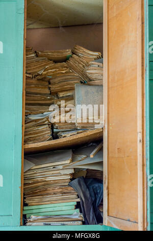 Books in the old falling apart bookcase Stock Photo