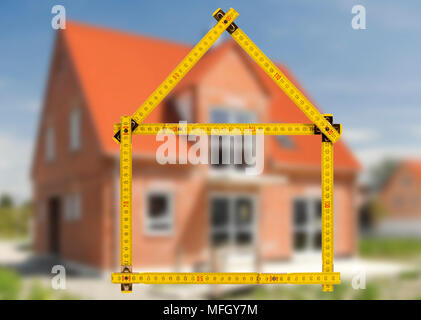 yardstick folded in form of an house in hand of an agent Stock Photo