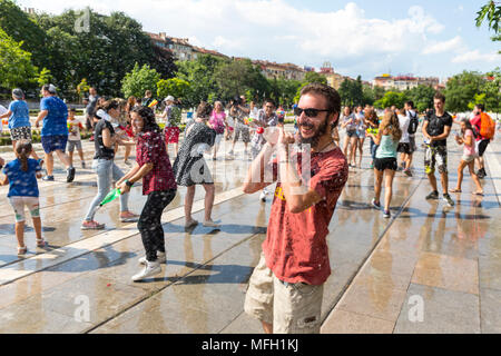 Sofia, Bulgaria - 8 July 2017: Children and adults participate in a fight with water guns and other water spray equipment in the center of Sofia. Stock Photo