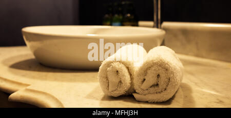 Hotel luxury bathroom sink and white towels. Closeup view with details Stock Photo