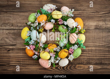 Decoration from easter eggs in shape of circle on wooden background Stock Photo