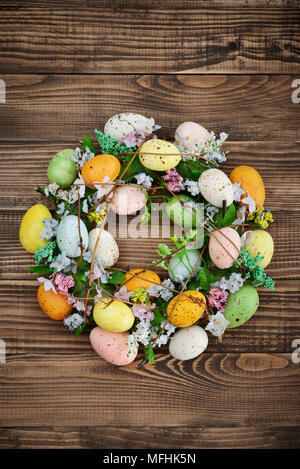 Decoration from easter eggs in shape of circle on painted wooden background Stock Photo