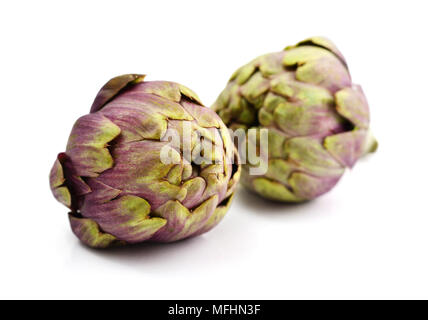 Two fresh artichokes with stem isolated on white background Stock Photo