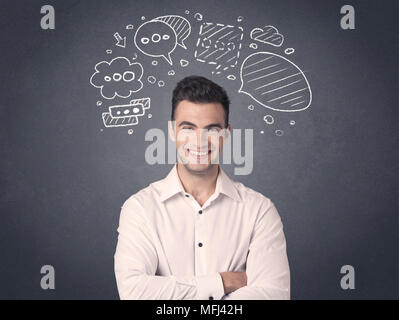 Young casual businessman with drawn speech bubbles over his head Stock Photo