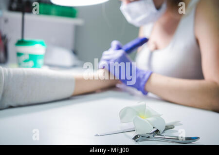 Manicure process in beauty salon, close up. Professional workplace Stock Photo