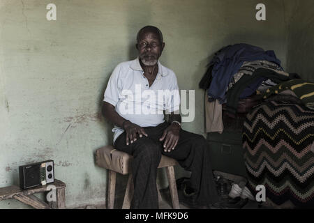 January 12, 2018 - Matatiele, Eastern Cape, South Africa - Thabo, 72, sits in his mud house and listens to the radio. He complains that there is nothing to do and that life is hard. The government has promised them all kinds of things, but has not delivered their promises..'We are not really living here. They have forgotten about us. (Credit Image: © Stefan Kleinowitz via ZUMA Wire) Stock Photo