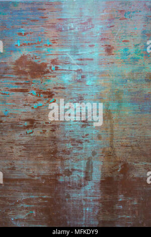 Rust streaks on a greenish metal surface create an interesting, colorful pattern Stock Photo