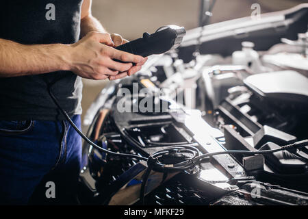 Auto Mechanic Testing Auto mechanic testing electrical system on automobile Stock Photo - Alamy