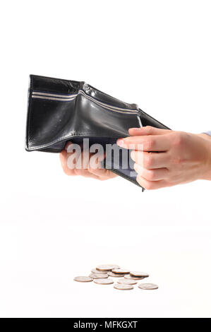 Hand holds empty wallet and falling out metal coins.  Female hands and falling coins Stock Photo