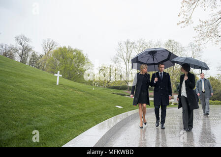 French President Emmanuel Macron (right), his wife, Brigitte Macron (center), and Katharine Kelley (left), superintendent, Arlington National Cemetery, visit the gravesite of Robert F. Kennedy at Arlington National Cemetery, Arlington, Virginia, April 24, 2018.  Macron’s visit to Arlington National Cemetery was part of the first official State Visit from France since President Francois Hollande came to Washington in 2014. President Macron also laid a wreath at the Tomb of the Unknown Soldier as part of his visit. (U.S. Army photo by Elizabeth Fraser / Arlington National Cemetery / released) Stock Photo