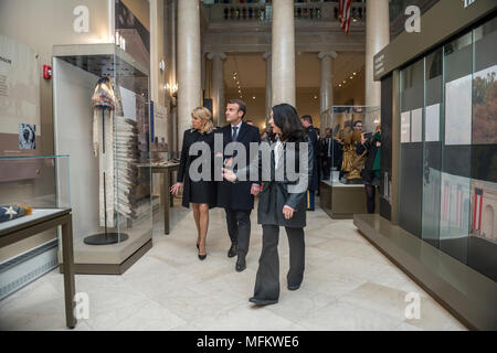 French President Emmanuel Macron (center) with his wife, Brigitte Macron (left), receive a tour from Karen Durham-Aguilera (right), executive director, Army National Military Cemeteries, of the Memorial Amphitheater Display Room at Arlington National Cemetery, Arlington, Virginia, April 24, 2018.  Macron’s visit to Arlington National Cemetery was part of the first official State Visit from France since President Francois Hollande came to Washington in 2014. The French President along with his wife also visited the gravesite of former President John F. Kennedy. (U.S. Army photo by Elizabeth Fra Stock Photo