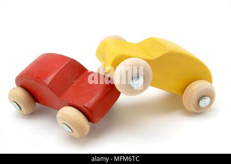 Two small wooden toy cars red and yellow, have had a head-on crash. Illustrating a traffic accident.    Bandphoto / COMPULSORY CREDIT: Hotshoe/Photosh Stock Photo