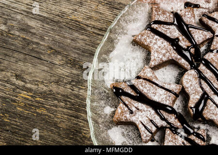Ginger biscuits with chocolate cream on a wooden background Stock Photo
