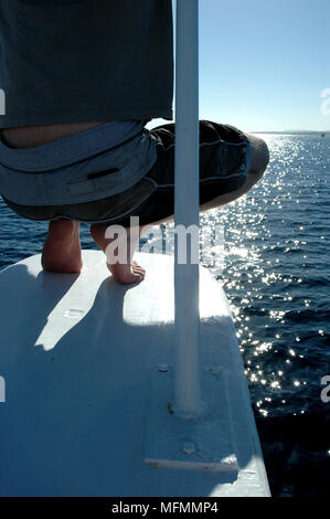 Rear view of a man crouching in a boat   Ref: CRB416 10009 056  Compulsory Credit: Kate Morwenna Healey/Photoshot Stock Photo