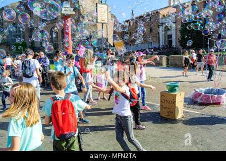 Street performance, A busker blowing giant soap bubbles with loops , rome, italy Stock Photo