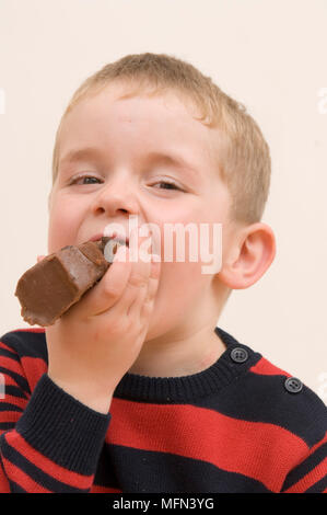 Close-up of a boy eating a piece of cake   Ref:   Compulsory Credit: Stock Photo