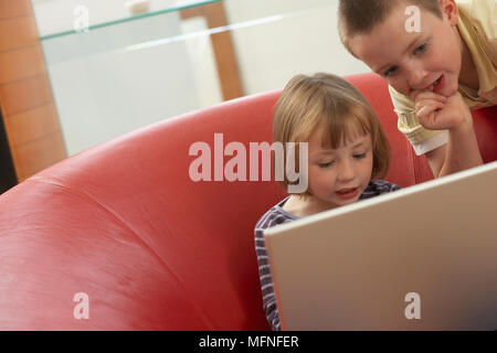 Close-up of a boy and his sister using a laptop   Ref: CRB257 10008 053  Compulsory Credit: Justin Canning/Phototshot Stock Photo