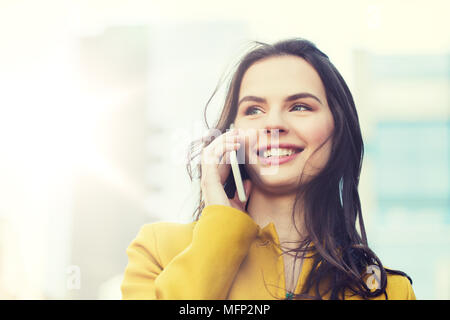 smiling young woman or girl calling on smartphone Stock Photo