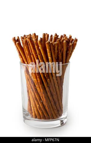 Crunchy salty pretzel sticks in glass isolated on white. Stock Photo