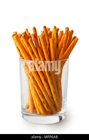 Crunchy thin cheese sticks in glass isolated on white. Stock Photo