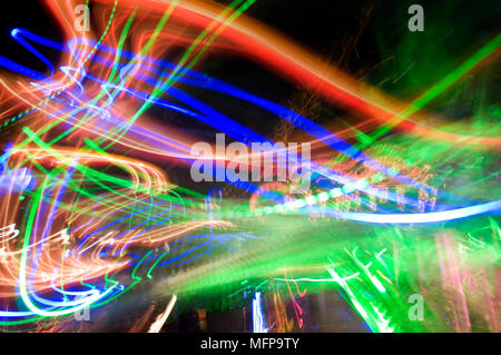 Swirling lights of an amusement ride at night Stock Photo - Alamy