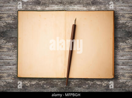 Blank brown old paper with ink pen put on grunge table use for texts display Stock Photo