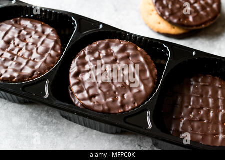 Chocolate Covered Round Jaffa Cookies in Plastic Box / Container. Dessert Concept. Stock Photo