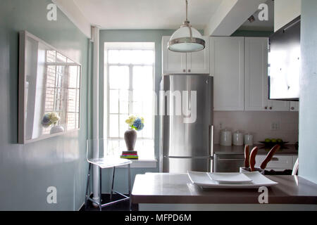 Blue kitchen with white fitted units in apartment, New York, USA Stock Photo