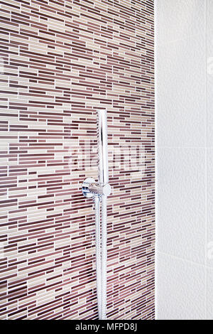 Corner of tiled shower with tap fitting Stock Photo