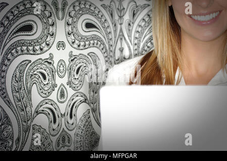 Mid section view of a businesswoman smiling with a laptop   Ref: CRUSC 10016 016  Compulsory Credit: Stuart Cox/Photoshot Stock Photo