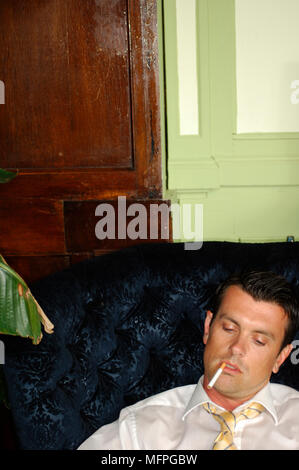 Close-up of a businessman sleeping on a couch   Ref: CRUSC 10016 039  Compulsory Credit: Stuart Cox/Photoshot Stock Photo