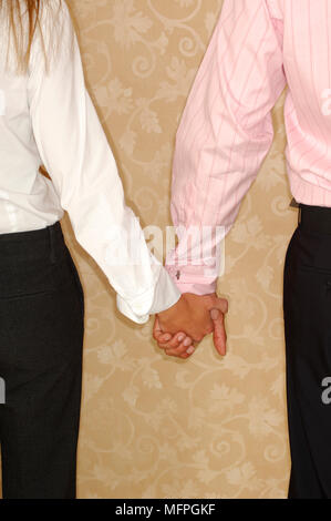Mid section view of a couple holding hands   Ref: CRUSC 10016 210  Compulsory Credit: Stuart Cox/Photoshot Stock Photo