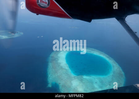 Aerial view of atolls, islands in Maldives, Asia, Indian Ocean. Archipelago, resort in tropical paradise seen from sky on airplane, plane, seaplane, f Stock Photo