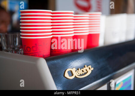 Take away coffee cups sitting on top of espresso machine Stock Photo