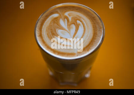 Take away coffee cups sitting on top of espresso machine Stock Photo