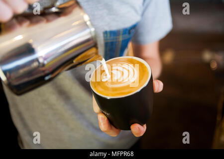 Take away coffee cups sitting on top of espresso machine Stock Photo