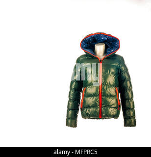Casual winter green feather fluff down jacket with red and blue on mannequin isolated on white background. Studio shot. Copy space. Stock Photo