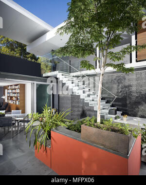 Exterior of modern house with external staircase leading down to garden Stock Photo