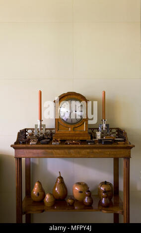 Clock and candlesticks on traditional style table Stock Photo