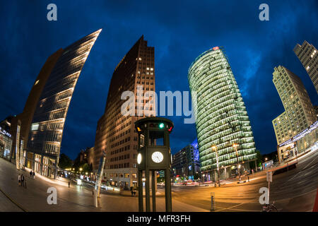 Berlin. Germany. Potsdamer Platz, fisheye night view of skyscrapers and the replica historical traffic light tower / clock, designed by Jean Krämer, a Stock Photo