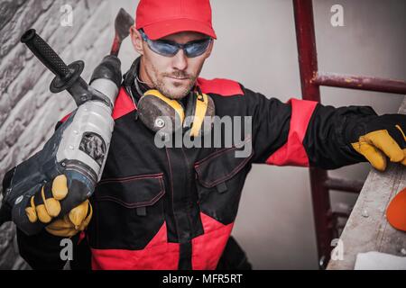 Caucasian Construction Worker with Heavy Duty Power Tool. Stock Photo