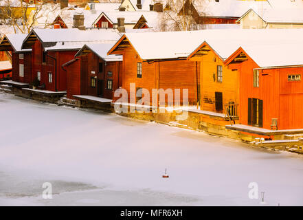Old wooden houses by frozen river,Porvoo,Finland,Europe Stock Photo