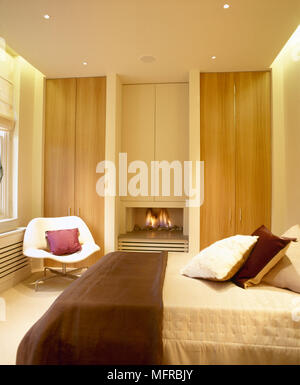 Bedroom With Wooden Built In Wardrobes And Fireplace Stock Photo