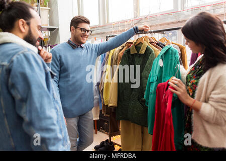 friends choosing clothes at vintage clothing store Stock Photo