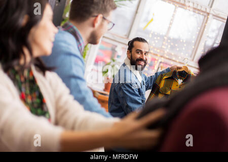 friends choosing clothes at vintage clothing store Stock Photo