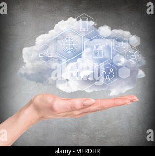 Hand holding cloud with different digital icons. Stock Photo